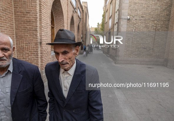 Two elderly Iranian men walk along an old street near a bazaar in the historical city of Tabriz, located 624 km northwest of Tehran in the E...