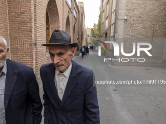 Two elderly Iranian men walk along an old street near a bazaar in the historical city of Tabriz, located 624 km northwest of Tehran in the E...