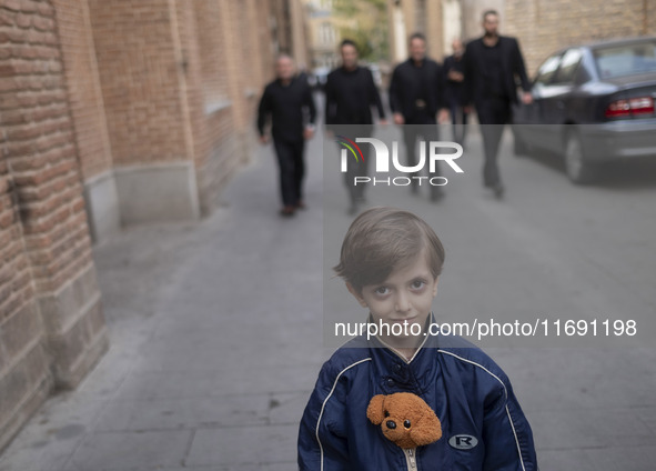 A young Iranian boy poses for a photograph on an old street near the historical mosques in the historical city of Tabriz, located 624 km (38...