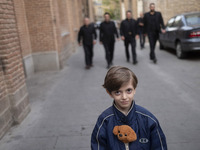 A young Iranian boy poses for a photograph on an old street near the historical mosques in the historical city of Tabriz, located 624 km (38...