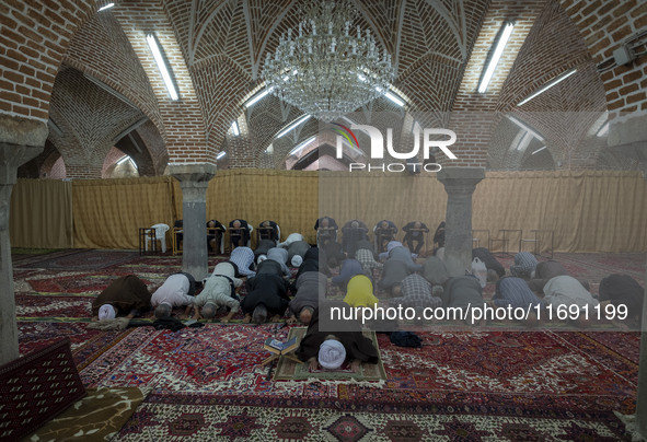 Iranian worshippers pray at a mosque in the historical city of Tabriz, located 624 km (388 miles) northwest of Tehran in the Eastern Azerbai...