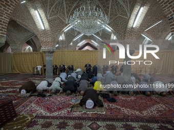 Iranian worshippers pray at a mosque in the historical city of Tabriz, located 624 km (388 miles) northwest of Tehran in the Eastern Azerbai...