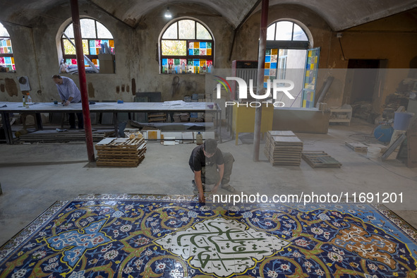 A young Iranian worker works at a ceramic tile workshop in the suburb of the historical city of Tabriz, located 624 km (388 miles) northwest...