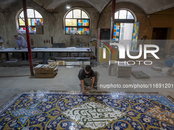 A young Iranian worker works at a ceramic tile workshop in the suburb of the historical city of Tabriz, located 624 km (388 miles) northwest...