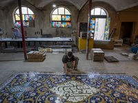 A young Iranian worker works at a ceramic tile workshop in the suburb of the historical city of Tabriz, located 624 km (388 miles) northwest...