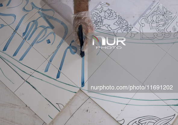 An Iranian artist works at a ceramic tile workshop in the suburb of the historical city of Tabriz, located 624 km (388 miles) northwest of T...