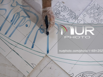 An Iranian artist works at a ceramic tile workshop in the suburb of the historical city of Tabriz, located 624 km (388 miles) northwest of T...