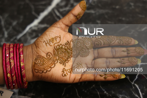 A woman displays the mehndi (henna) design applied to her hand during the Diwali and Karwa Chauth Bazaar in Mississauga, Ontario, Canada, on...