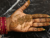 A woman displays the mehndi (henna) design applied to her hand during the Diwali and Karwa Chauth Bazaar in Mississauga, Ontario, Canada, on...