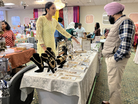 Women display traditional jewelry for customers during the Diwali and Karwa Chauth Bazaar in Mississauga, Ontario, Canada, on October 20, 20...