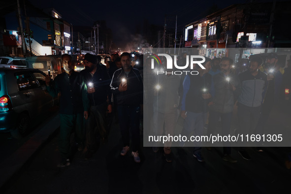 People from all walks of life protest against recent targeted killings of Indian laborers working in Ganderbal amid tight security in Baramu...