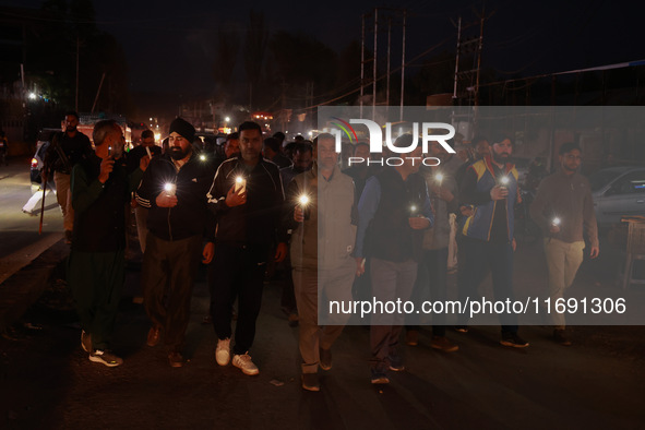 People from all walks of life protest against recent targeted killings of Indian laborers working in Ganderbal amid tight security in Baramu...