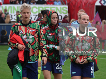 In Dagenham, England, on October 20, 2024, Kathrine Moller Kuhl of Arsenal, Lina Hurtig of Arsenal, and Beth Mead of Arsenal participate in...