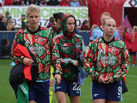 In Dagenham, England, on October 20, 2024, Kathrine Moller Kuhl of Arsenal, Lina Hurtig of Arsenal, and Beth Mead of Arsenal participate in...