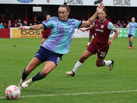 Caitlin Foord of Arsenal takes on Lime Mengwen of West Ham United WFC during the Barclays FA Women's Super League soccer match between West...