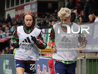 In Dagenham, England, on October 20, 2024, Kathrine Moller Kuhl of Arsenal and Lina Hurtig of Arsenal participate in the Barclays FA Women's...