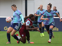 In Dagenham, England, on October 20, 2024, Kyra Cooney-Cross of Arsenal Women, Viviane Asseyi of West Ham United, and Emily Fox of Arsenal c...