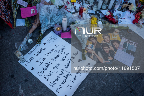 Flowers and cards are left at a memorial dedicated to former One Direction singer Liam Payne at Washington Square Park in New York, New York...