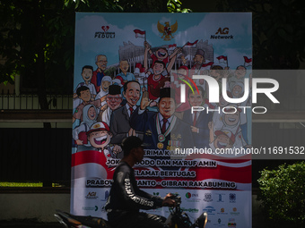 Several motorists pass by a banner expressing congratulations from various levels of society in Medan, North Sumatra, Indonesia, on October...