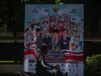 Several motorists pass by a banner expressing congratulations from various levels of society in Medan, North Sumatra, Indonesia, on October...