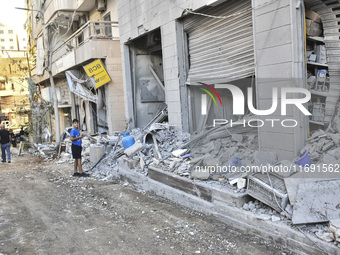 A view of the destruction after the Israeli army targets Bank Kared Al Hassan with a series of airstrikes on the suburb of Dahieh, as debris...