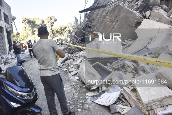 A view of the destruction after the Israeli army targets Bank Kared Al Hassan with a series of airstrikes on the suburb of Dahieh, as debris...