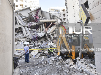 A view of the destruction after the Israeli army targets Bank Kared Al Hassan with a series of airstrikes on the suburb of Dahieh, as debris...