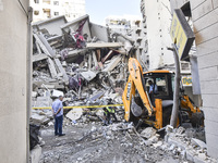 A view of the destruction after the Israeli army targets Bank Kared Al Hassan with a series of airstrikes on the suburb of Dahieh, as debris...