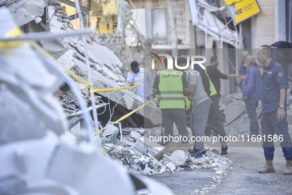 A view of the destruction after the Israeli army targets Bank Kared Al Hassan with a series of airstrikes on the suburb of Dahieh, as debris...