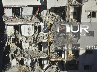 A view of the destruction after the Israeli army targets Bank Kared Al Hassan with a series of airstrikes on the suburb of Dahieh, as debris...