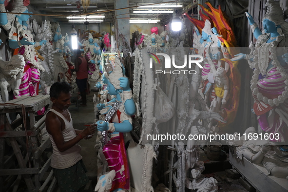 An artist paints an idol of the Hindu goddess Kali inside a workshop in Kolkata, India, on October 21, 2024. Diwali comes from the Sanskrit...