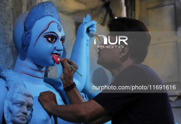 An artist paints an idol of the Hindu goddess Kali inside a workshop in Kolkata, India, on October 21, 2024. Diwali comes from the Sanskrit...