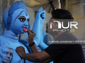 An artist paints an idol of the Hindu goddess Kali inside a workshop in Kolkata, India, on October 21, 2024. Diwali comes from the Sanskrit...