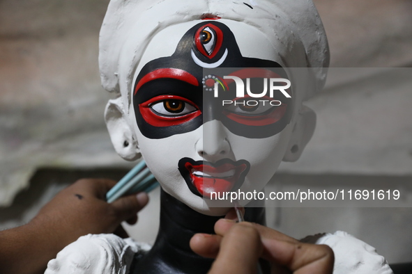 An artist paints an idol of the Hindu goddess Kali inside a workshop in Kolkata, India, on October 21, 2024. Diwali comes from the Sanskrit...