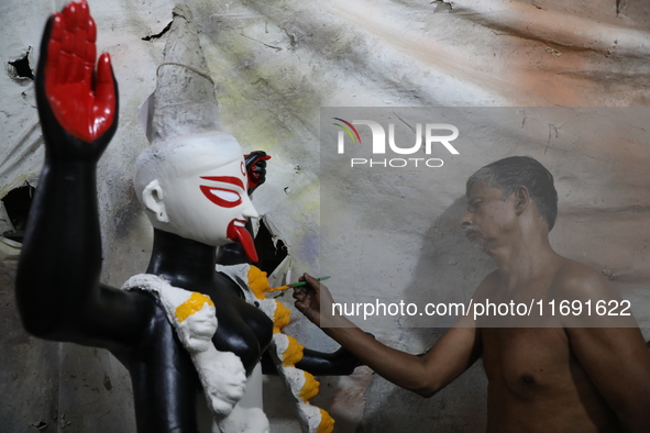 An artist paints an idol of the Hindu goddess Kali inside a workshop in Kolkata, India, on October 21, 2024. Diwali comes from the Sanskrit...