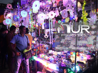 People buy decorative lights ahead of the Diwali festival in Kolkata, India, on October 21, 2024. Diwali comes from the Sanskrit word deepav...