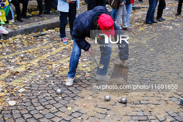 A member of CLAP Montmartre pours earth on the road to play petanque there after the expulsion of the ZADists from rue Junot, who protest ag...