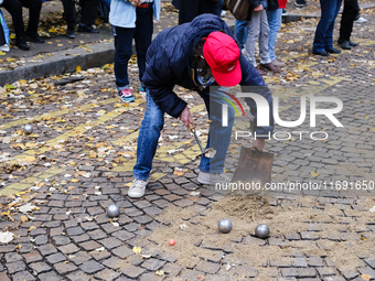 A member of CLAP Montmartre pours earth on the road to play petanque there after the expulsion of the ZADists from rue Junot, who protest ag...