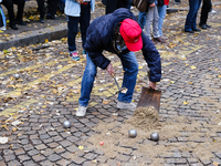 A member of CLAP Montmartre pours earth on the road to play petanque there after the expulsion of the ZADists from rue Junot, who protest ag...