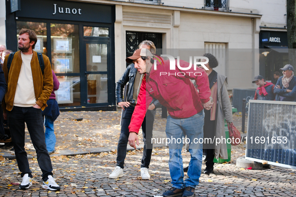 Members of the Lepic Abbesses Petanque Club (CLAP Montmartre) protest against the closure of their pitch by playing on the cobblestones of t...