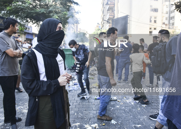 Displaced people who flee Israeli bombardment in Beirut's southern suburbs clash with Lebanese security forces attempting to evict them from...