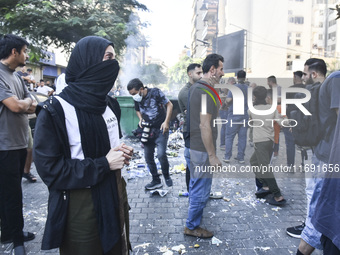 Displaced people who flee Israeli bombardment in Beirut's southern suburbs clash with Lebanese security forces attempting to evict them from...