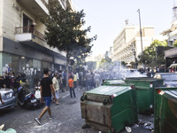 Displaced people who flee Israeli bombardment in Beirut's southern suburbs clash with Lebanese security forces attempting to evict them from...