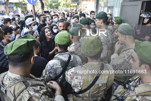 Displaced people who flee Israeli bombardment in Beirut's southern suburbs clash with Lebanese security forces attempting to evict them from...