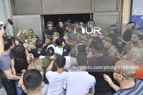 Displaced people who flee Israeli bombardment in Beirut's southern suburbs clash with Lebanese security forces attempting to evict them from...