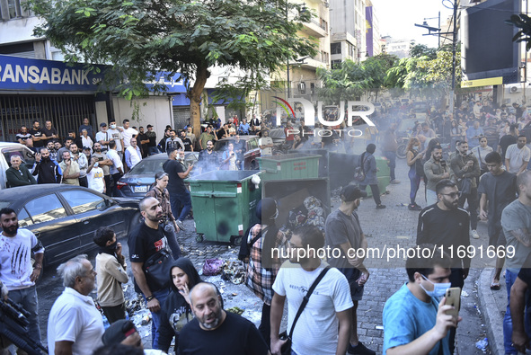 Displaced people who flee Israeli bombardment in Beirut's southern suburbs clash with Lebanese security forces attempting to evict them from...