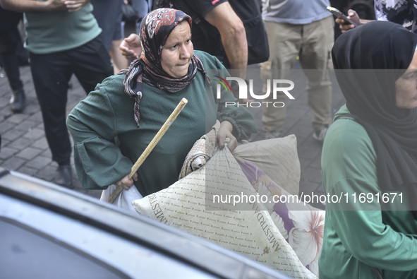 Displaced people who flee Israeli bombardment in Beirut's southern suburbs clash with Lebanese security forces attempting to evict them from...