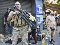 Displaced people who flee Israeli bombardment in Beirut's southern suburbs clash with Lebanese security forces attempting to evict them from...