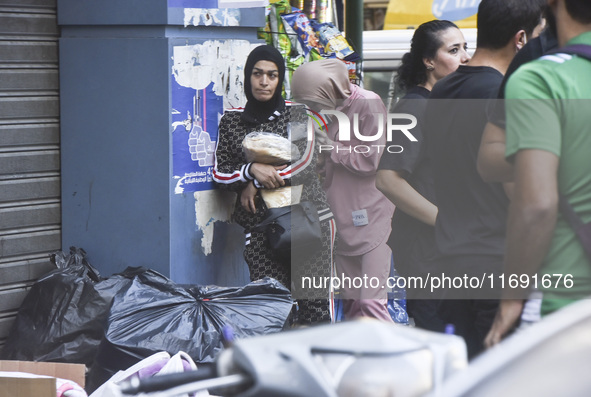 Displaced people who flee Israeli bombardment in Beirut's southern suburbs clash with Lebanese security forces attempting to evict them from...