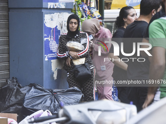 Displaced people who flee Israeli bombardment in Beirut's southern suburbs clash with Lebanese security forces attempting to evict them from...